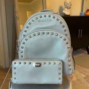 Michael Kors, gray leather studded backpack with matching wallet.